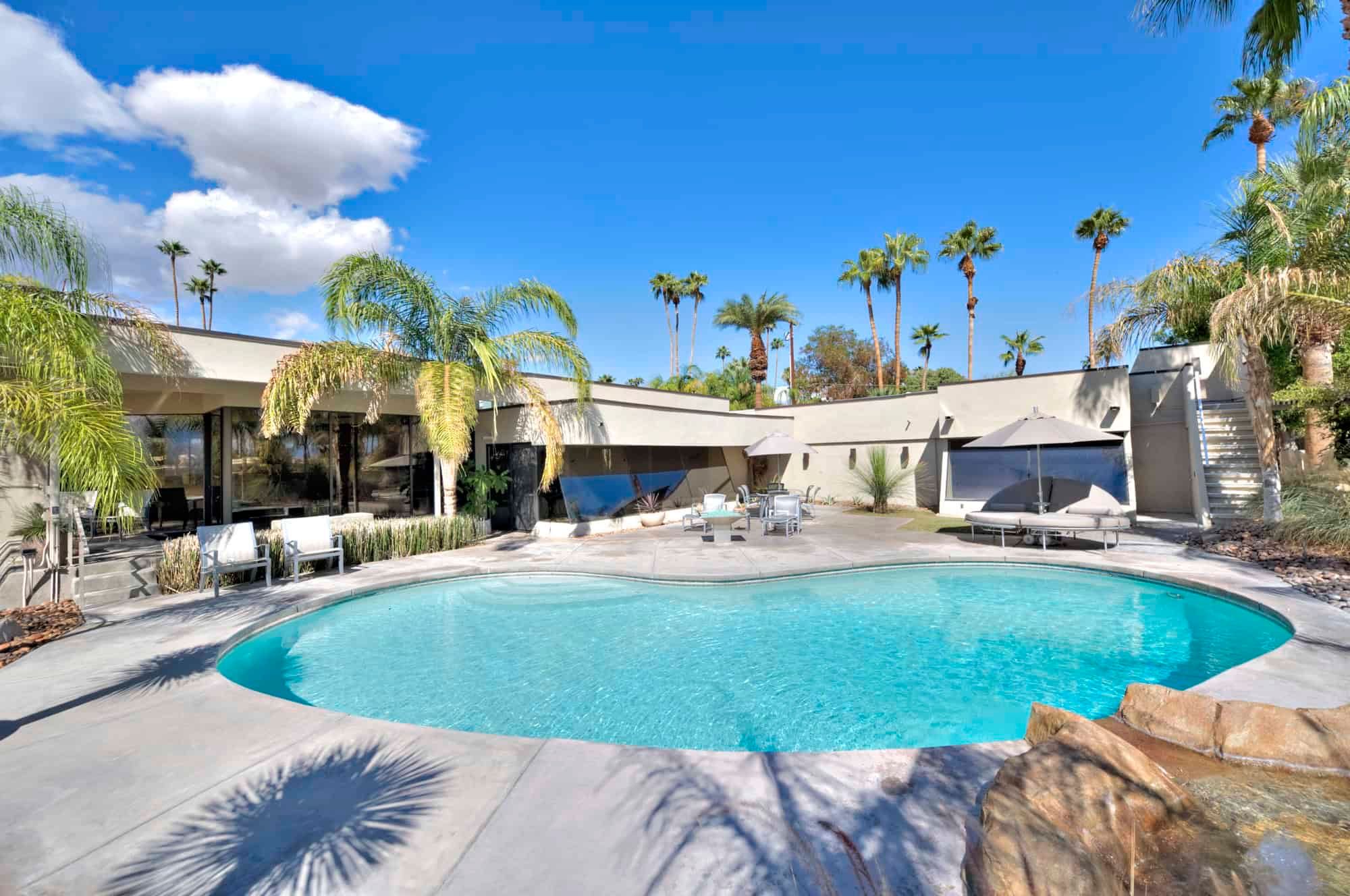 Backyard pool with palm trees at a desert home