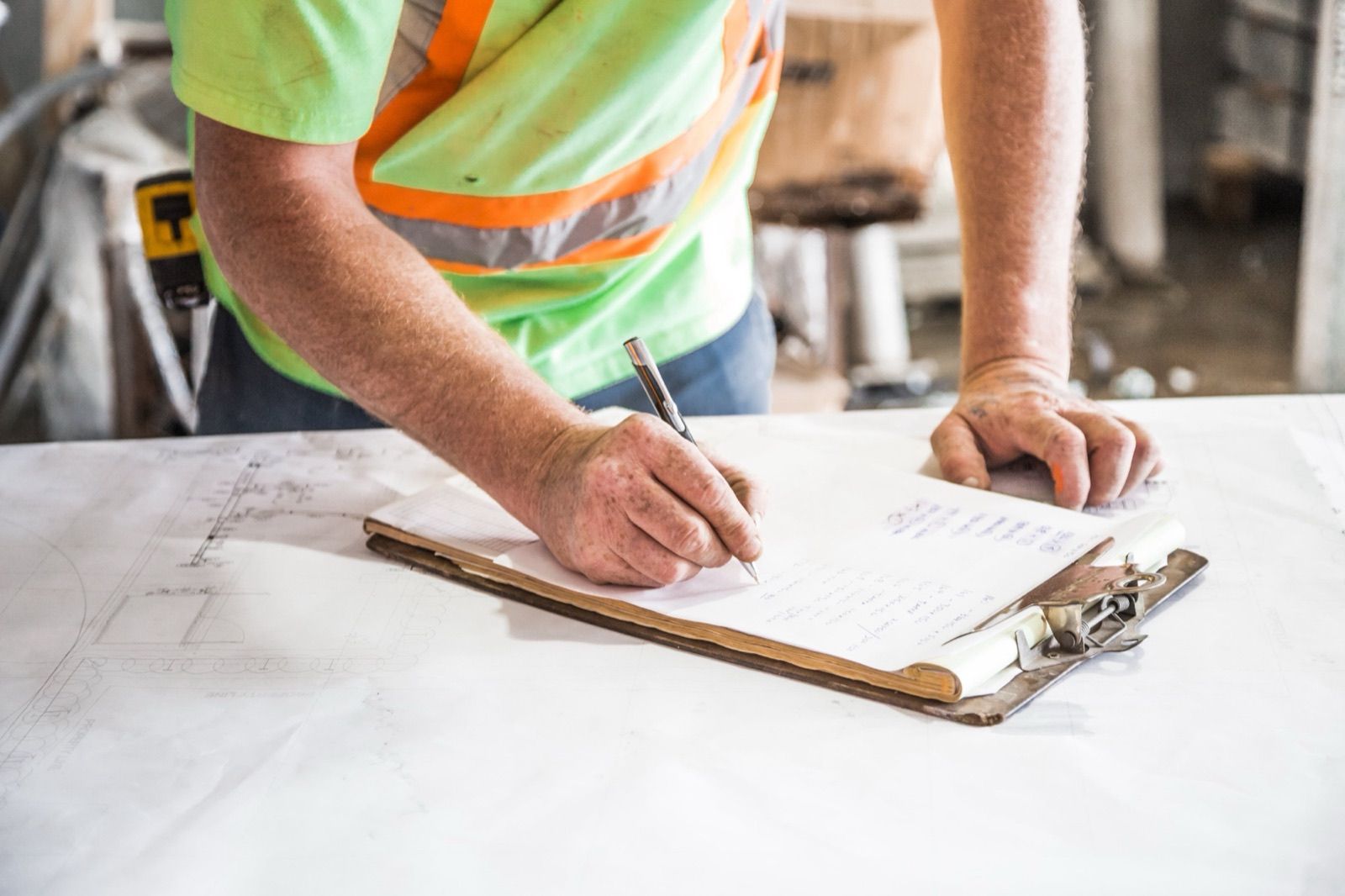 Writing up a job quote on a clipboard